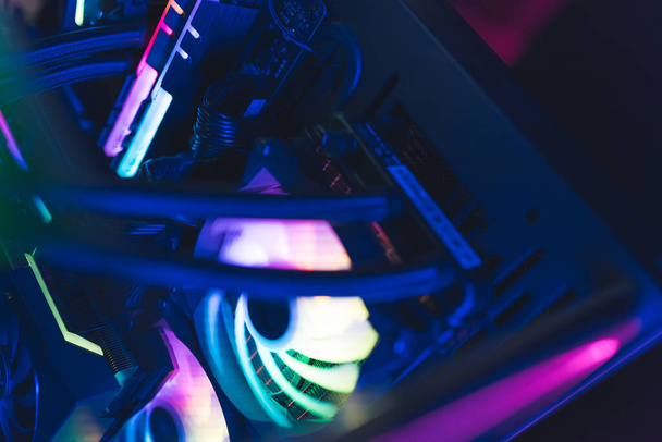 Close-up shot of a colorful bright custom computer cooler with led lights. Insides of a pc. High quality photo - 写真・画像
