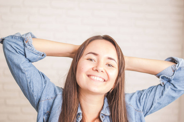 positive woman smiling on a light background. High quality photo - Фото, зображення