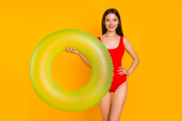 Photo of shiny positive woman wear swimsuit holding green buoy isolated yellow color background. - Фото, изображение