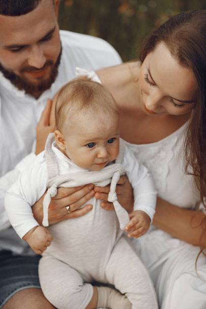 Parents with daughter. Family in a field. Newborn girl. Woman in a white dress. - Fotografie, Obrázek