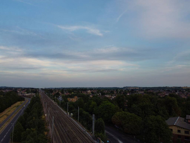 Aerial footage high angle view of Luton Town of England and Railways Station and Train on Tracks at Sunset - Fotó, kép