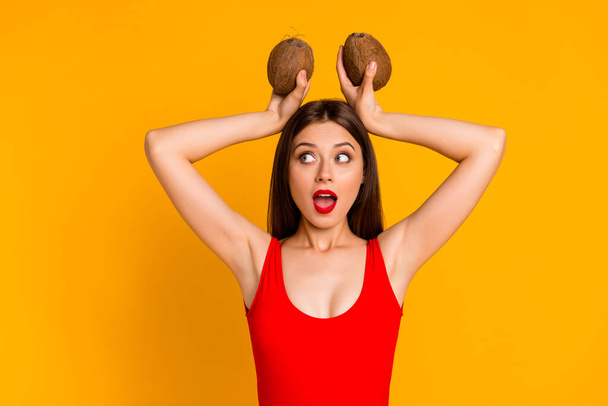 Photo of funny dreamy lady dressed bodysuit coco nut ears looking empty space isolated yellow color background. - Foto, Imagem