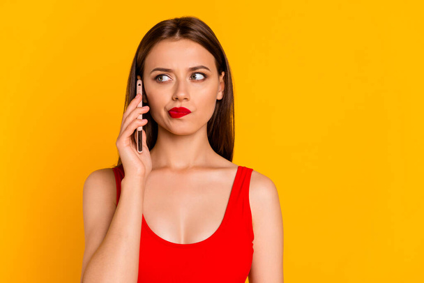 Photo of pretty girl speak communicate telephone hesitate think isolated on yellow color background. - Foto, immagini