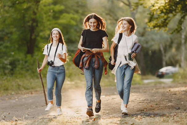 Adventure, travel, tourism, hike and people concept. Three girls in a forest. - Fotó, kép