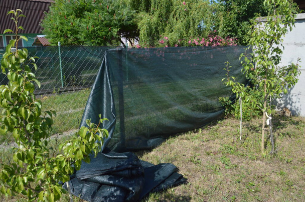 Installation of a shading net on a the chain-link fence - Photo, image