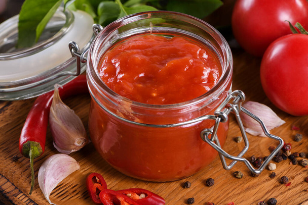Traditional classic tomato sauce with spices and herbs. Fragrant dressing for various dishes. Taste and simplicity. - Photo, image