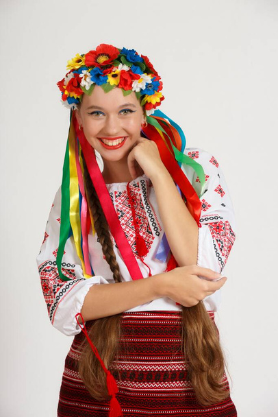 Beautiful Ukrainian girl in national costume vyshyvanka. Studio shoot on white background. Vse bude Ukraine - Foto, immagini