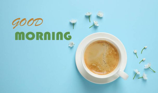 Good Morning! White flowers and coffee on light blue background, flat lay - Фото, изображение