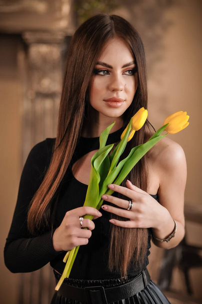 beautiful young woman with tulips in hands - Fotoğraf, Görsel