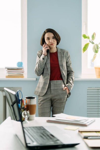 Young professionals, gen z working, first job. Confident young businesswoman working at her workplace in office. Company worker, entrepreneur - Foto, Imagen