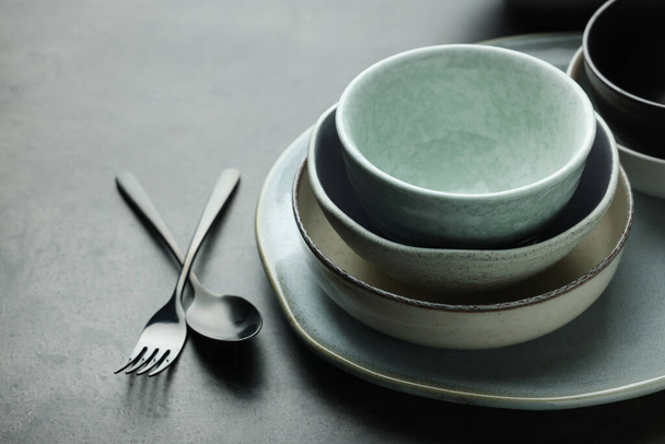 Set of stylish empty dishware and cutlery on grey table, closeup - Foto, Imagem