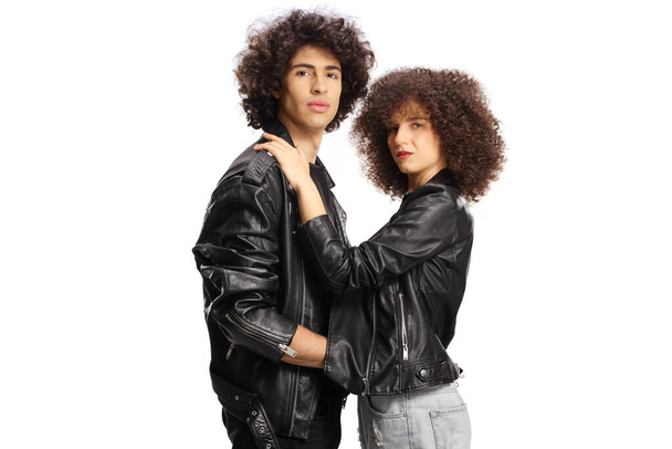 Young couple with leather jackets hugging each other and looking at camera isolated on white background - Foto, Imagem