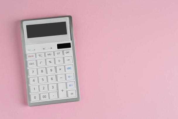 White calculator on pink background, top view. Space for text - Zdjęcie, obraz