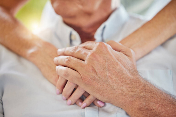 Closeup doctor holding hands on patients chest showing support during recovery. Unrecognizable health care worker demonstrating chest cpr in case of emergency heart attack, teaching chest compressions - Foto, immagini