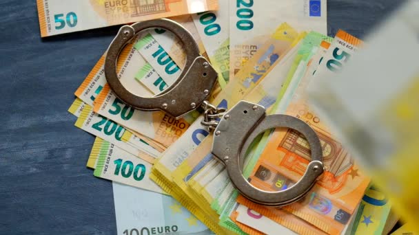 economic crimes.Handcuffs and falling euro bills . 4k footage - Metraje, vídeo