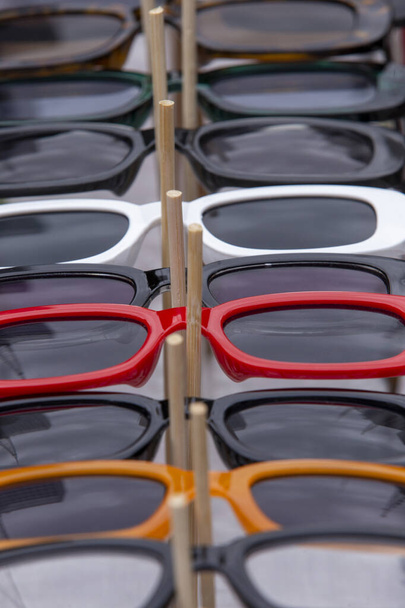closeup of sunglasses at a street market on a sunny day in Sao Paulo, Brazil. Selective focus - Foto, Imagem
