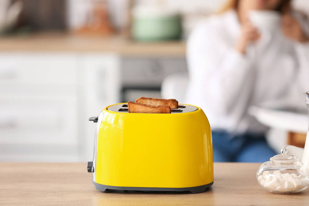 Modern toaster on kitchen table - Foto, imagen