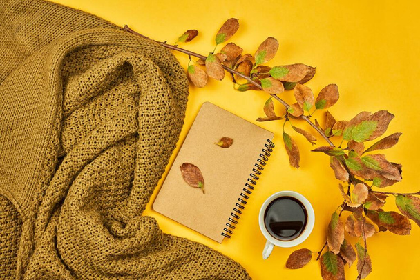 Cozy fall atmosphere with a cup of coffee, autumn leaves and war - Photo, Image