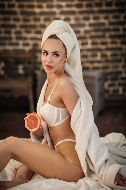 beautiful young woman with a towel in her hands - Fotografie, Obrázek