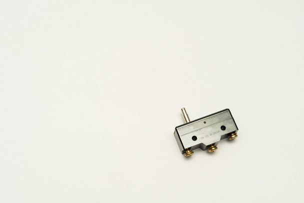 Limit switch sensor of the machine. Tiny limit switch for mechanical movement and actuators limits. isolated, white background of limit switch, control device, electrical equipment in control system. - Foto, afbeelding