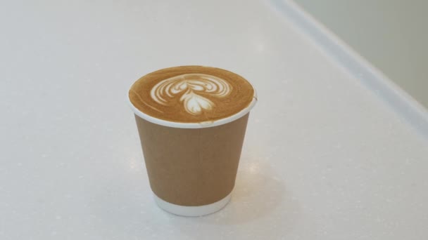 grab a cup of coffee on white table, cappuccino hot coffee in paper cup - Video