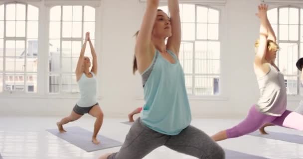 4k video footage of a group of young woman exercising at a yoga studio together. - Πλάνα, βίντεο