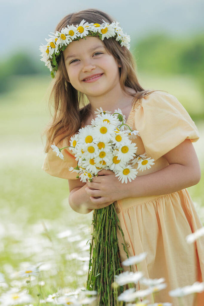 Boldog lány a mezőn virágokkal. Kiváló minőségű fénykép - Fotó, kép