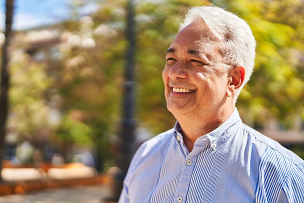 Senior man smiling confident standing at park - Zdjęcie, obraz