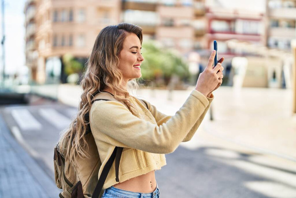 Young woman tourist making selfie by the smartphone at street - Photo, image