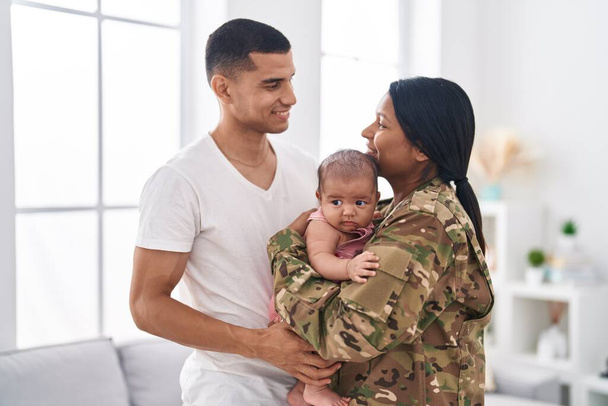 Hispanic family army soldier hugging each other at home - Photo, Image