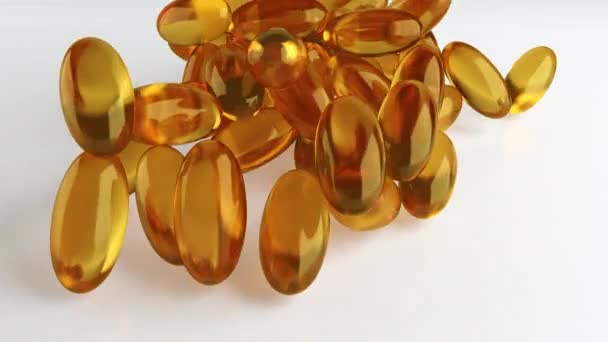 Soft gelatin capsules for containing oily drugs and nutritional supplements like vitamin A, and E. 3D rendering motion. Falling Omega-3 fish oil liquid gel capsules falling over white background - Séquence, vidéo