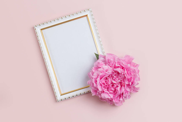 Invitation or greeting card mockup with photo frame and pink dutch peony. - Foto, afbeelding