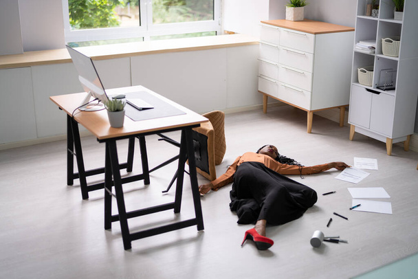 Full length of young businesswoman fallen from office chair - Fotoğraf, Görsel