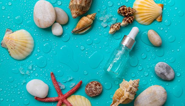 Moisturizing cosmetic product on sea background. Hyaluronic acid. Selective focus. Spa. - Foto, afbeelding