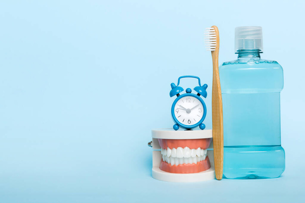Mouthwash and other oral hygiene products on colored table top view with copy space. Flat lay. Dental hygiene. Oral care kit. Dentist concept. - Photo, Image