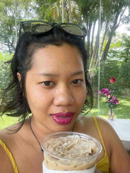 Selfie of woman dinking iced coffee - Photo, image