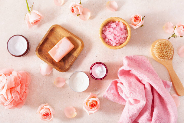 skincare products and rose flowers. natural cosmetics for home spa treatment - Foto, afbeelding