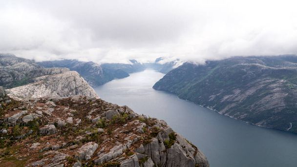 Impressive Lysefjord between high mountains on a cloudy day passing Preikestollen - Zdjęcie, obraz