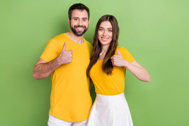 Portrait of two cheerful positive people hand finger demonstrate thumb up isolated on green color background. - Fotografie, Obrázek
