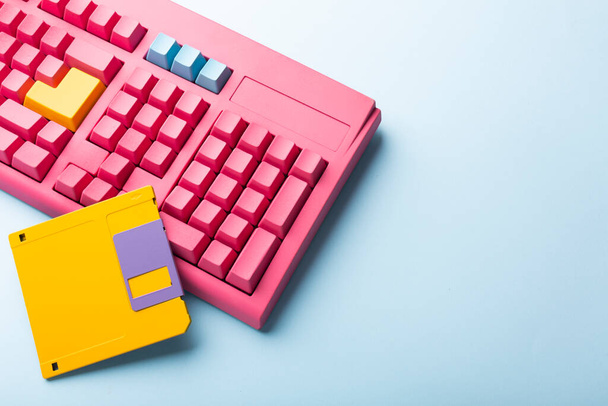 Floppy disks and keyboard on bright colored backgrounds. High quality photo - Valokuva, kuva