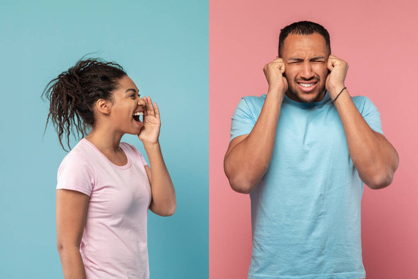 Conflict, family relationship problems. Angry black lady screaming at husband, mad man closing eyes and covering ears with hands isolated on blue and pink studio wall - Foto, Bild
