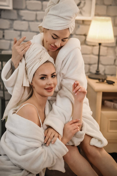 beautiful young woman in bathrobe and towel on bed in bathroom - Fotografie, Obrázek