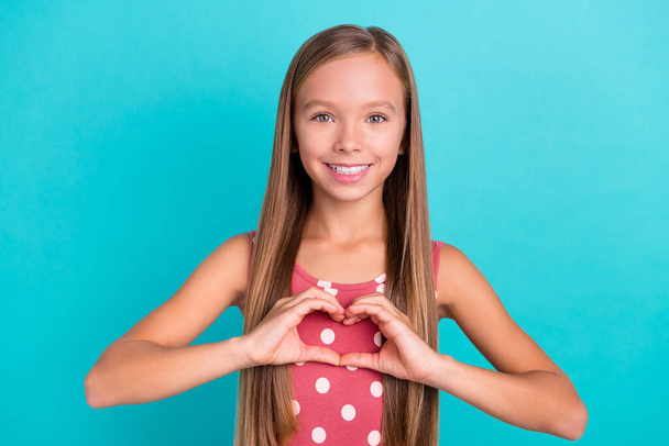 Photo of sweet shiny small girl wear pink dress showing arms heart isolated turquoise color background. - Foto, imagen