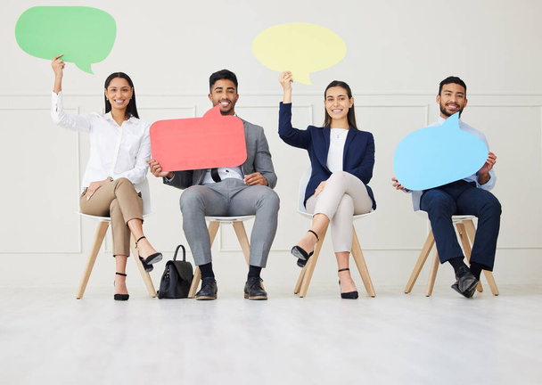 Group of diverse businesspeople holding speech bubble while waiting for interview. Team of applicants together. Candidates in line for job opening, vacancy, office opportunity with unique opinions. - Foto, Imagen