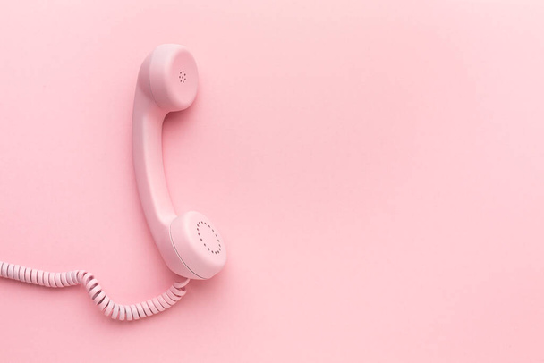 Pink telephone receiver on pink background . High quality photo - Zdjęcie, obraz