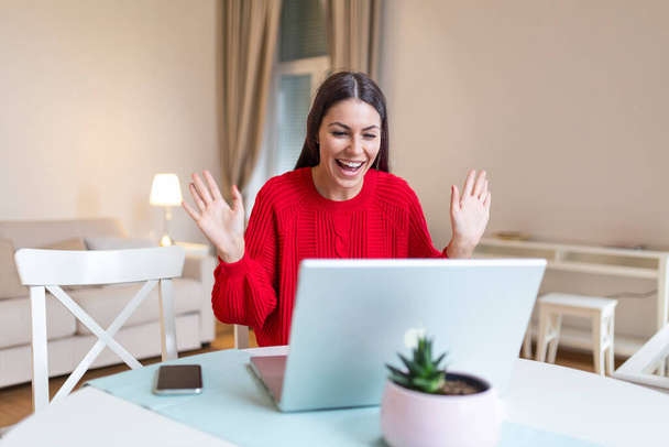 Young woman waving at laptop and talking to her friends via video call, girl student talking by video conference call, female teacher trainer tutoring by webcam, online training, e-coaching concept - Foto, Imagem