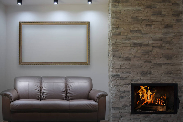 Conceptual composite image of a luxury apartment with sofa and fireplace and large empty picture frame for your artwork visualisation (not real property). - Photo, Image