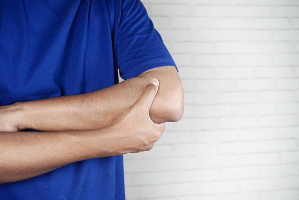 man with elbow pain. Pain relief concept - Foto, immagini