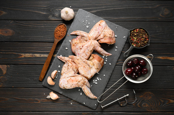 Marinated chicken wings with sweet cherry on a rustic wooden background - Foto, imagen