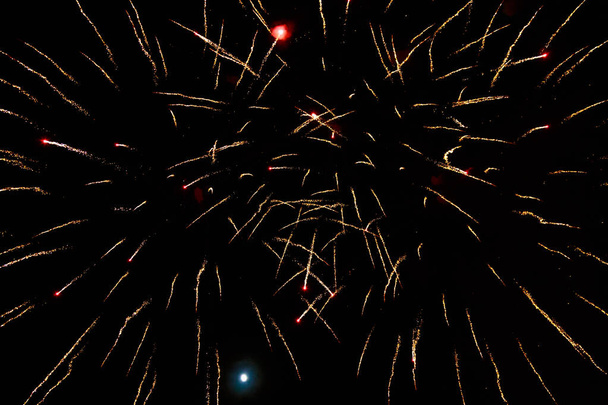 Very beautiful fireworks against the black sky with copy space for text or inscriptions. A graphic resource for design. Blank for the designer. Underlay or undercoat. - Photo, Image